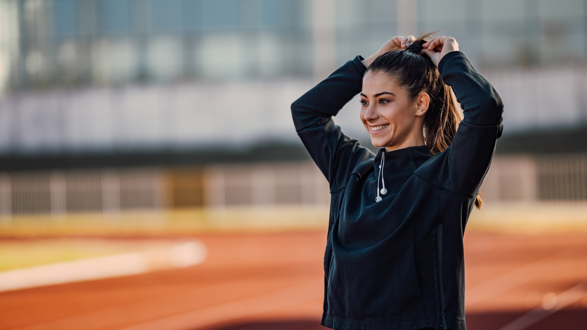 Woman stretching on a track and field
